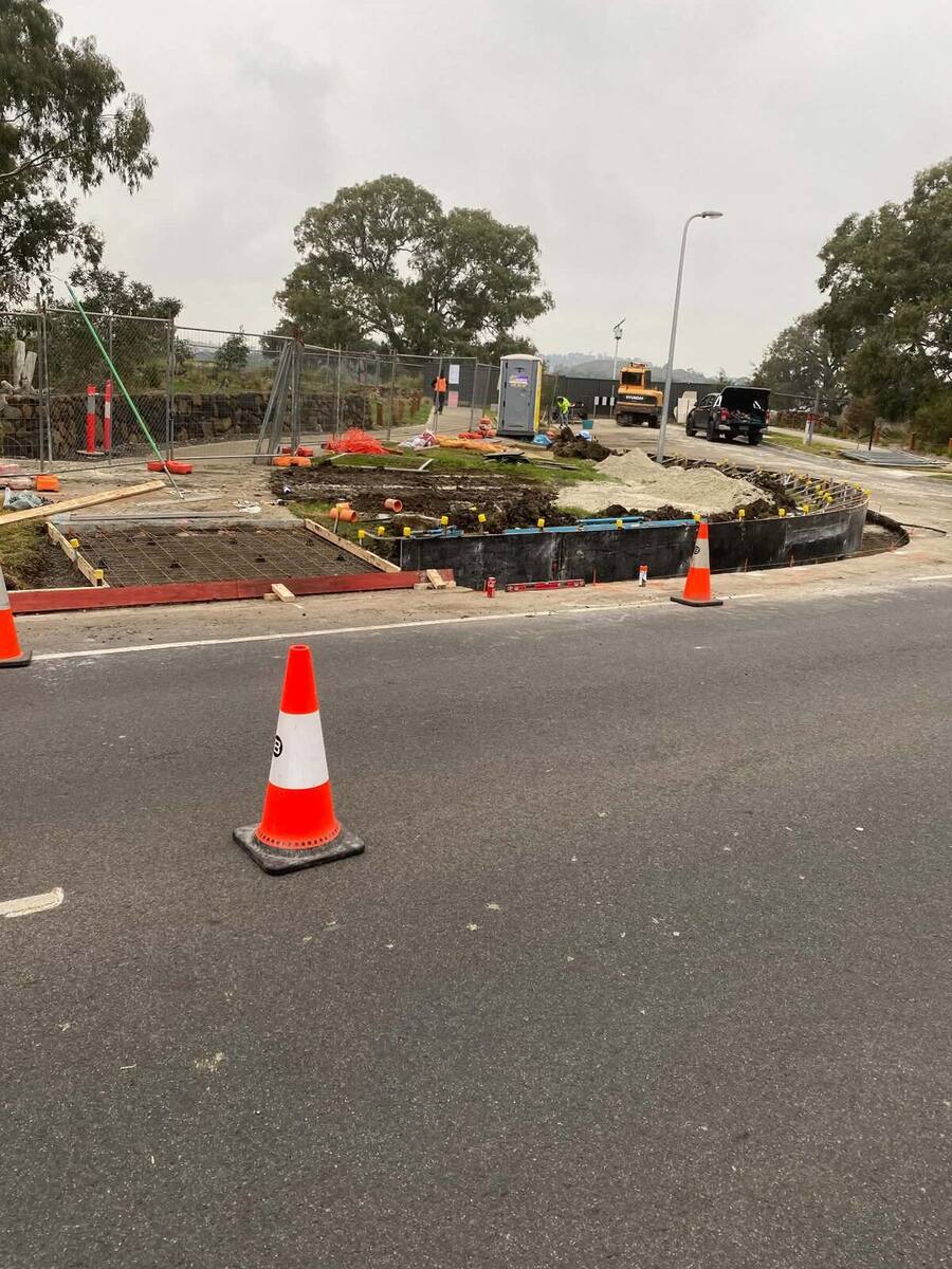 Formwork and steel mesh set for a concrete pour at a street corner